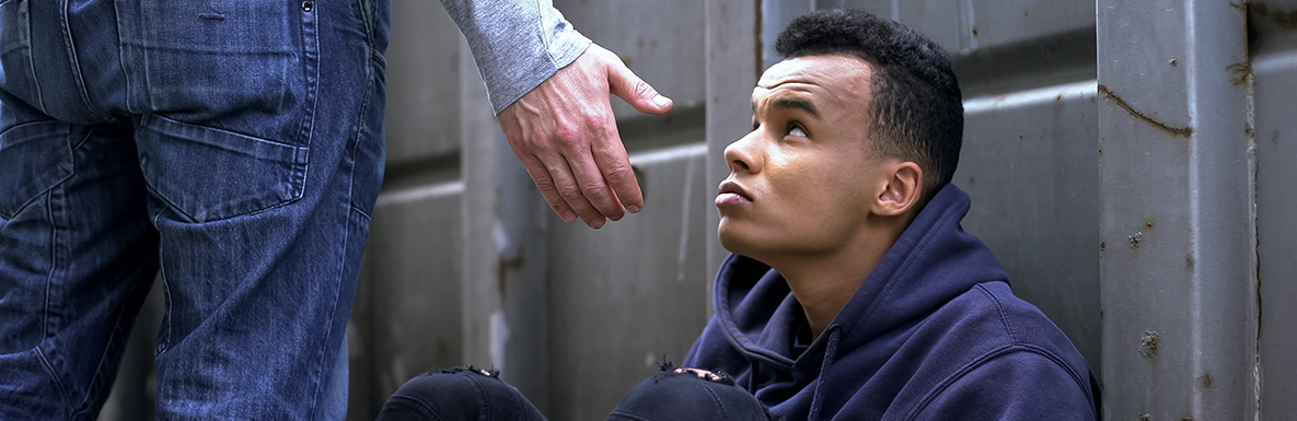 Man reaching out hand to another man