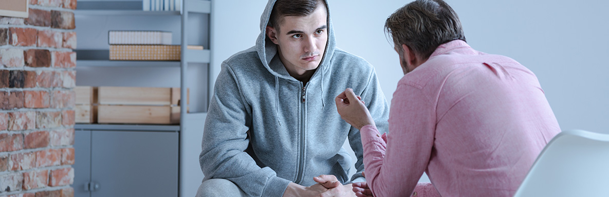 Counselor talking to young man